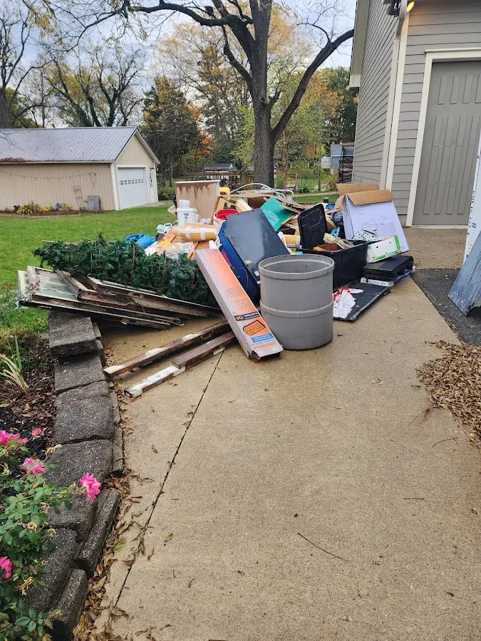 Dumpster being loaded with debris for 12 Yard Dumpster Rental in Sheridan